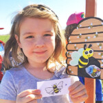 child holding picture of bee